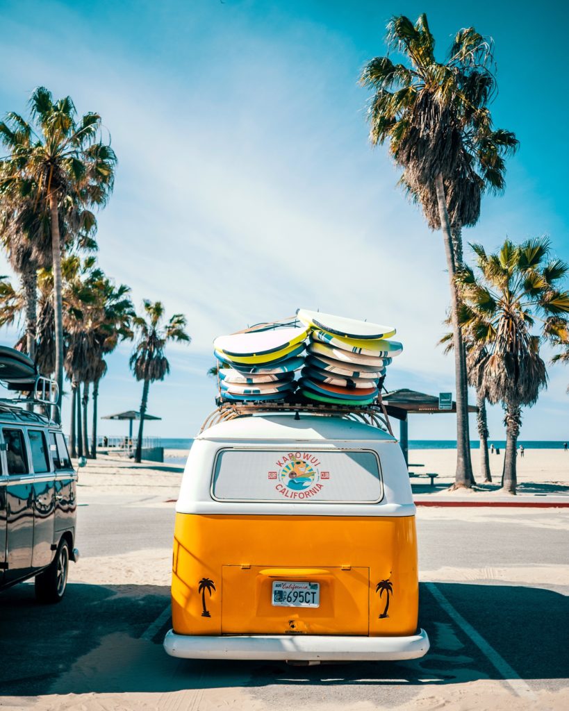 photo of yellow van at the beach