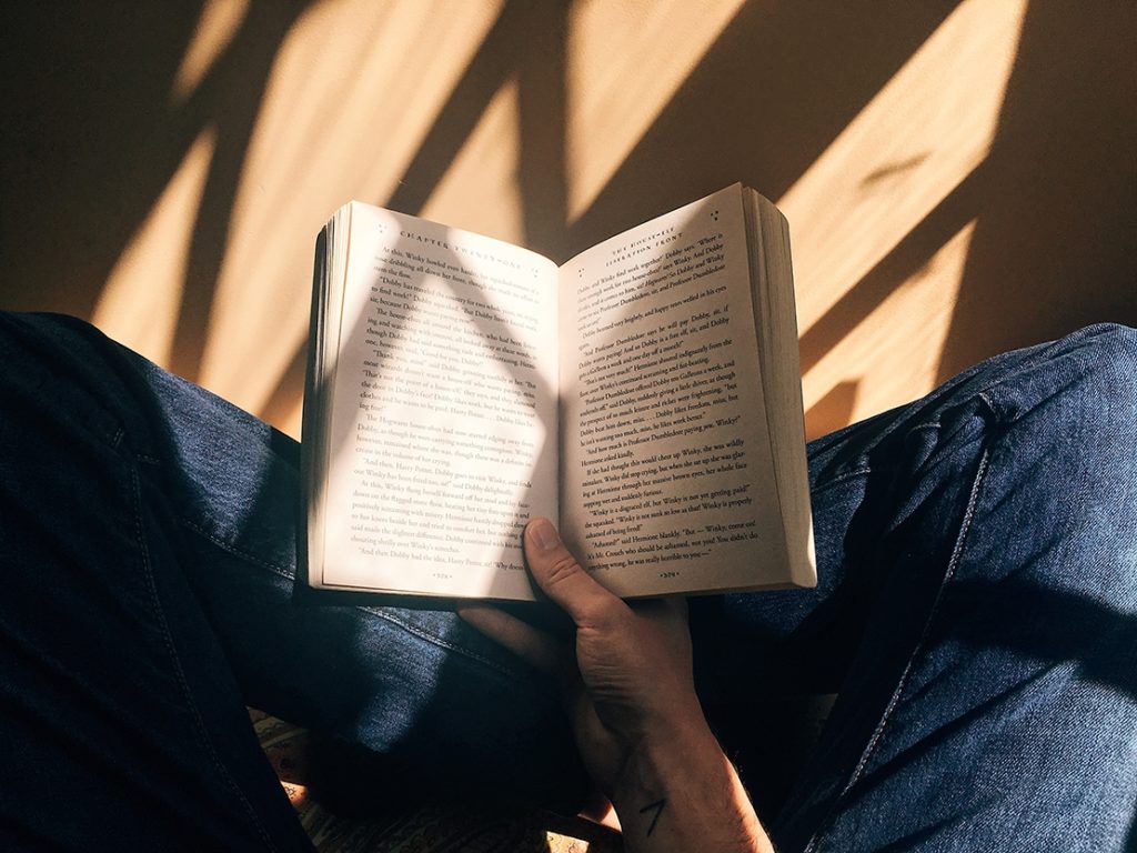 photo of a person holding a book