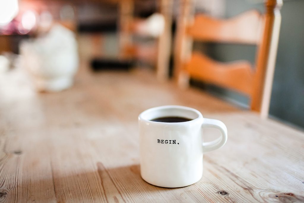 photo of a coffee mug with the word begin