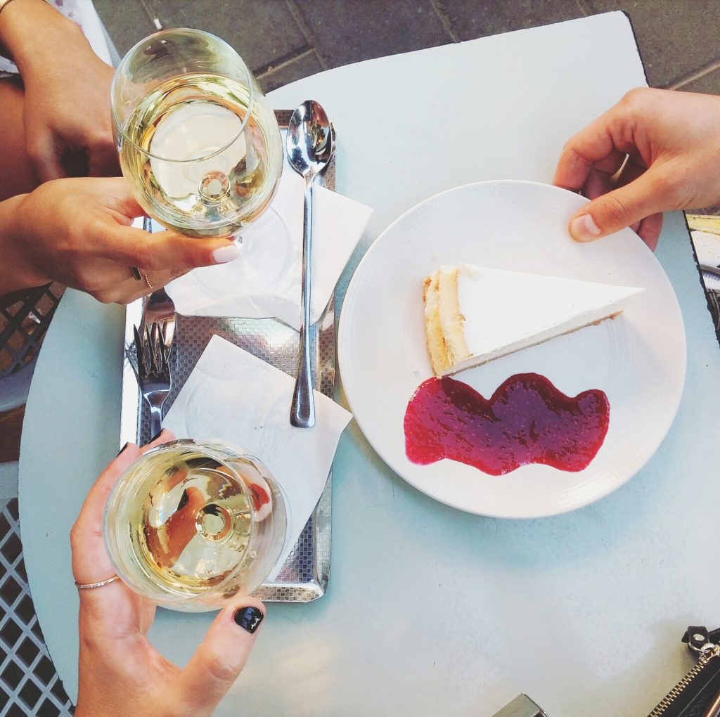 photo of a table with wine and cheesecake from above