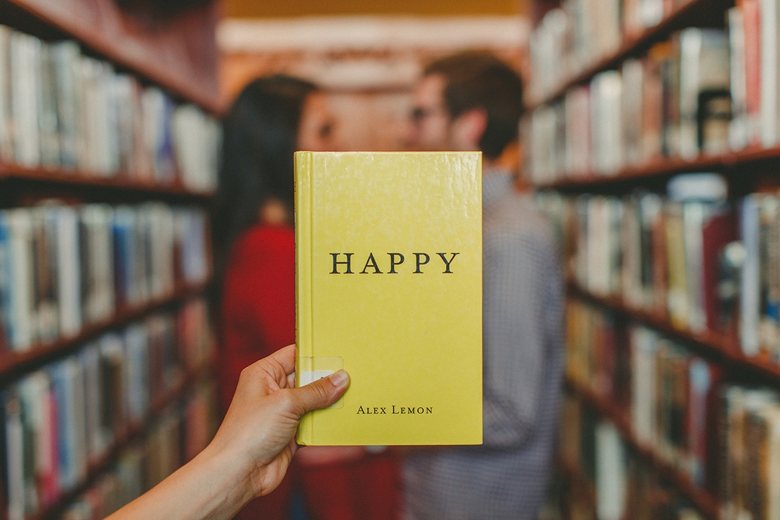 a yellow book with the word happy on the cover