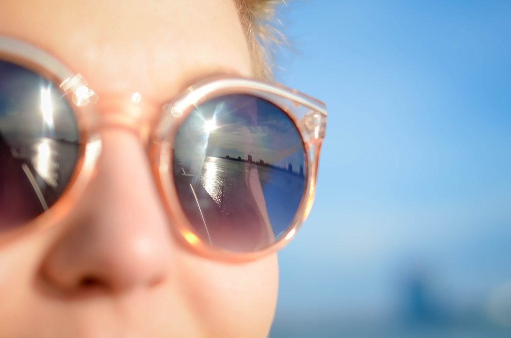 reflection of skyline in sunglasses